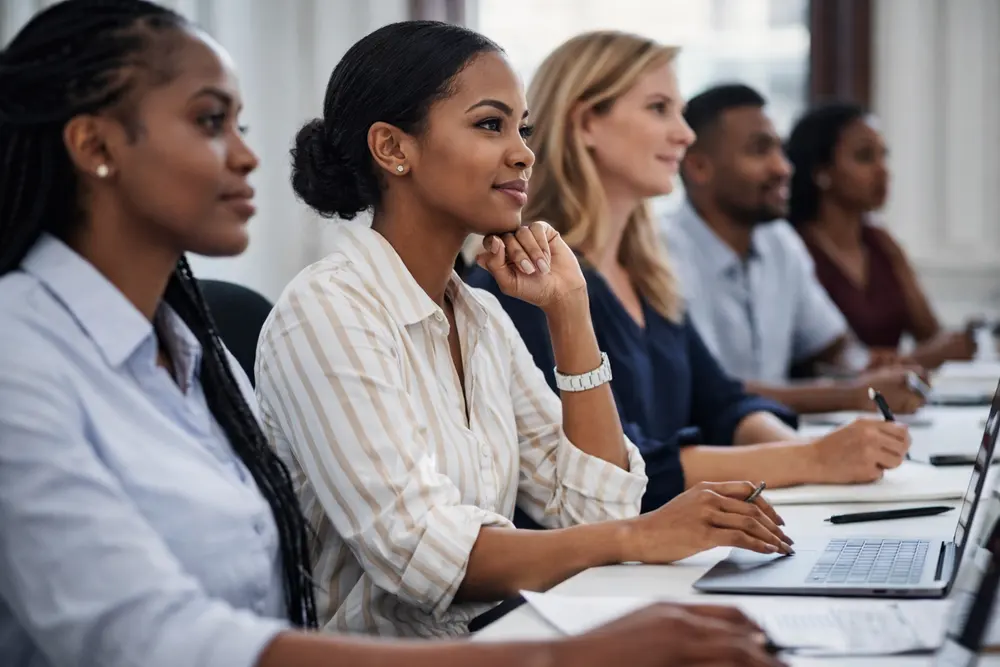 Professionals in a working session around a boardroom table