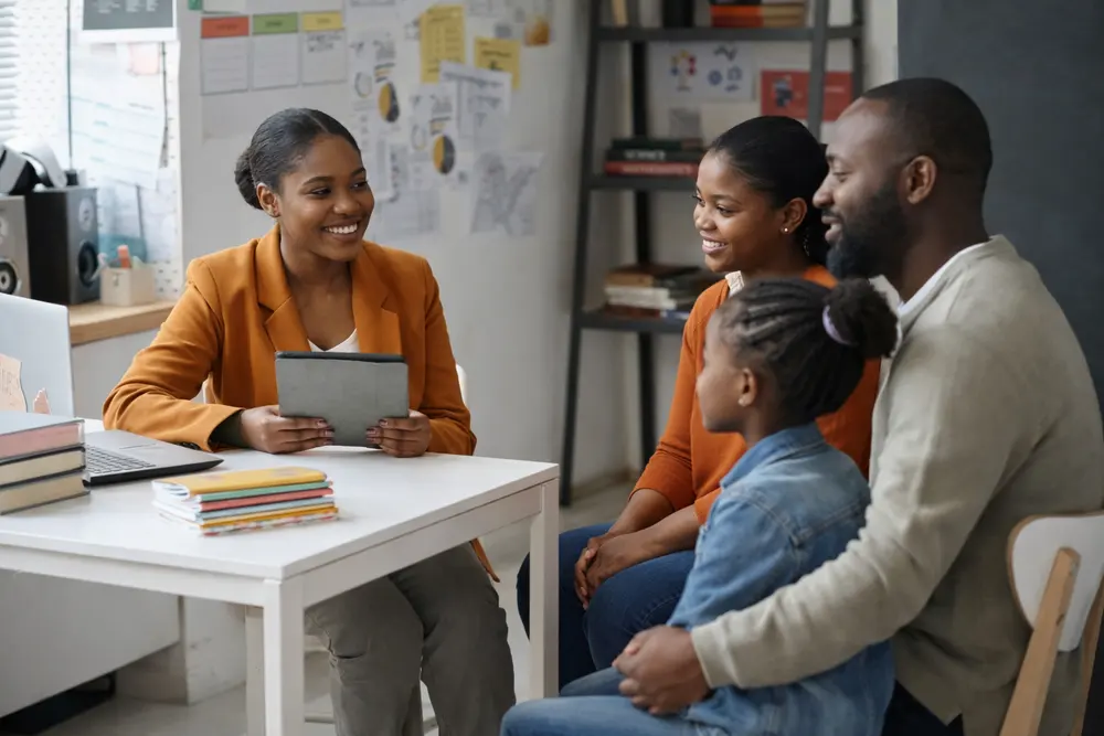 A school principal in conversation with a family